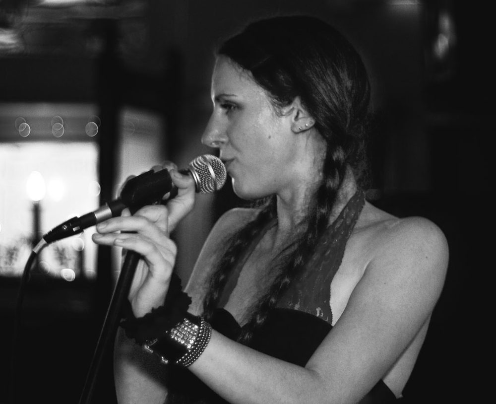 Lizzy singing into a microphone